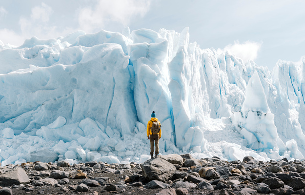 A man posing on the ice formation of the Perito Moreno glacier, Argentina